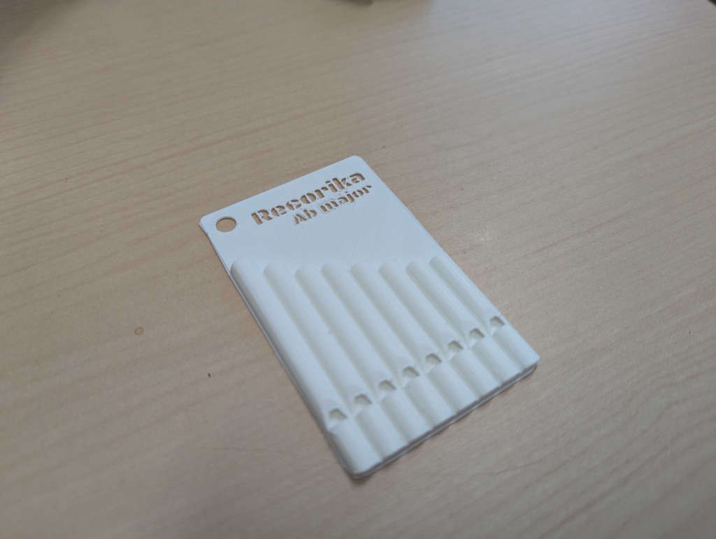 A printed Recorika card, eight pipes from long to short